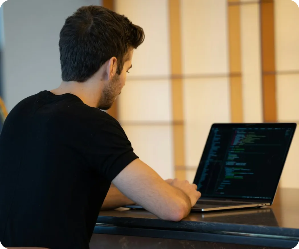 a developer writing code on a laptop